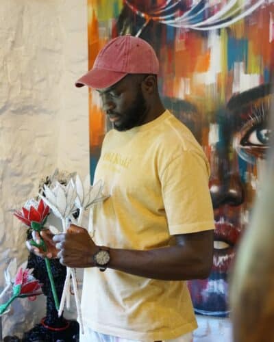 Tinashe, Paivepo's owner, holding a beaded protea sculptures